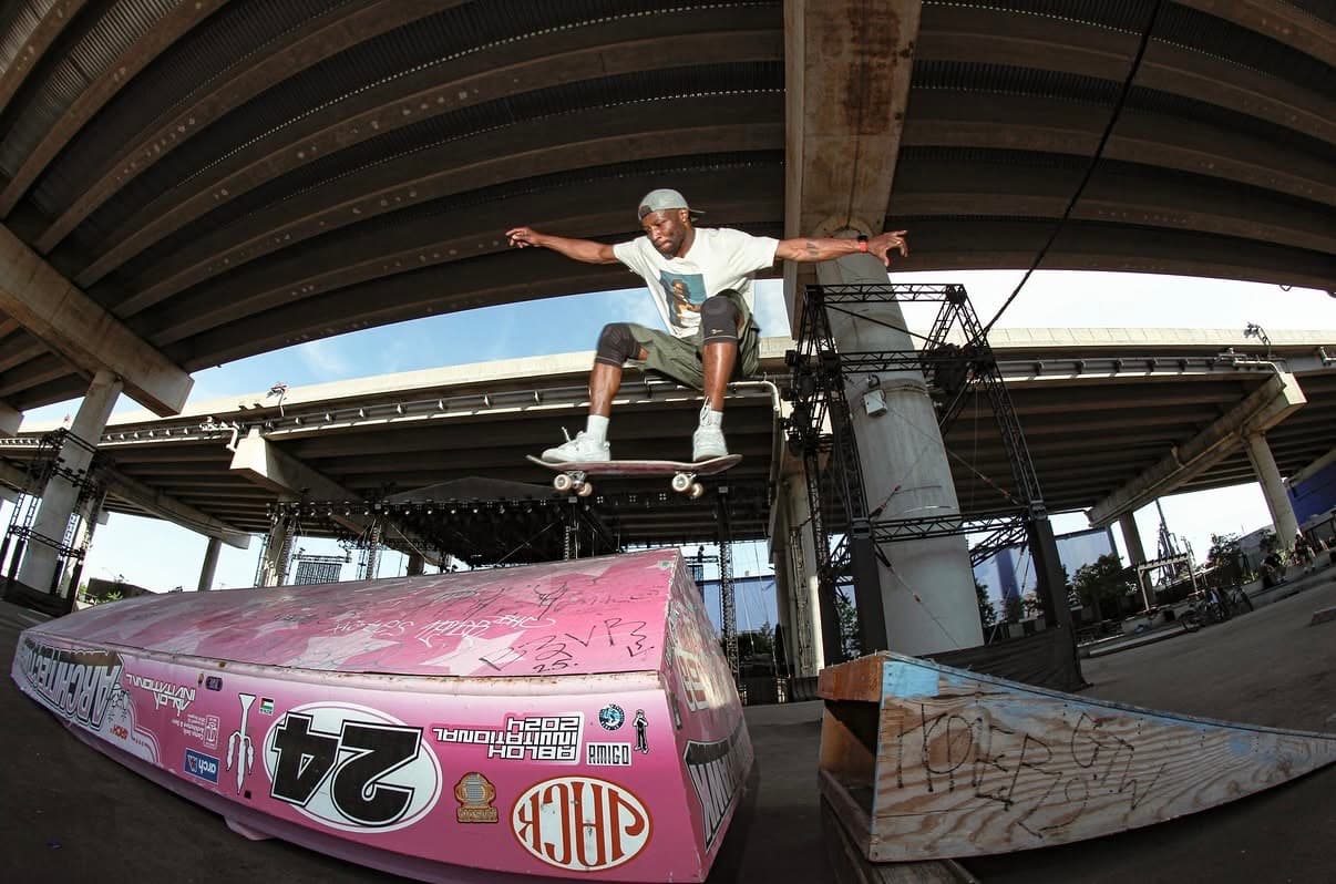 Leon Toppin performing a trick at an outdoor covered skatepark in Brooklyn