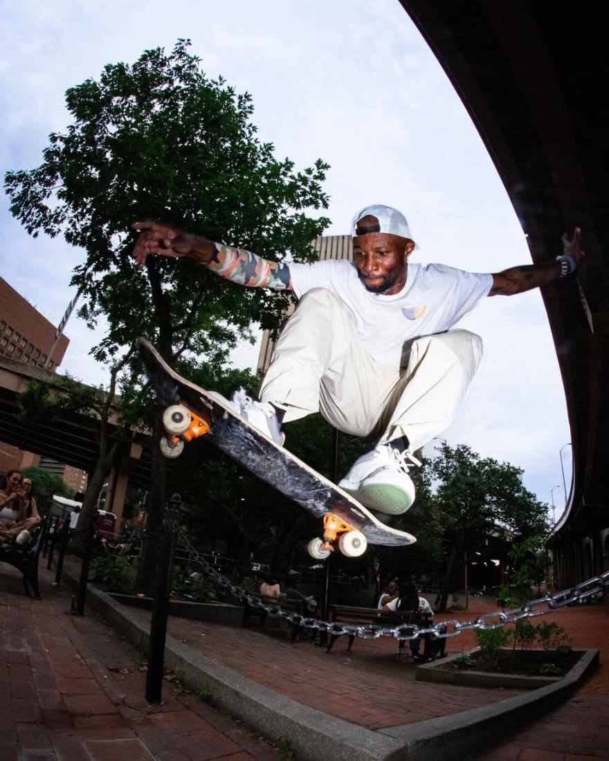 Leon Toppin performing an ollie over a chain in the city