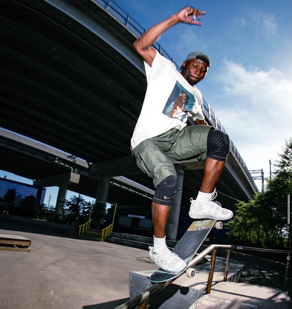 Leon Toppin grinding a rail while wearing protective knee pads