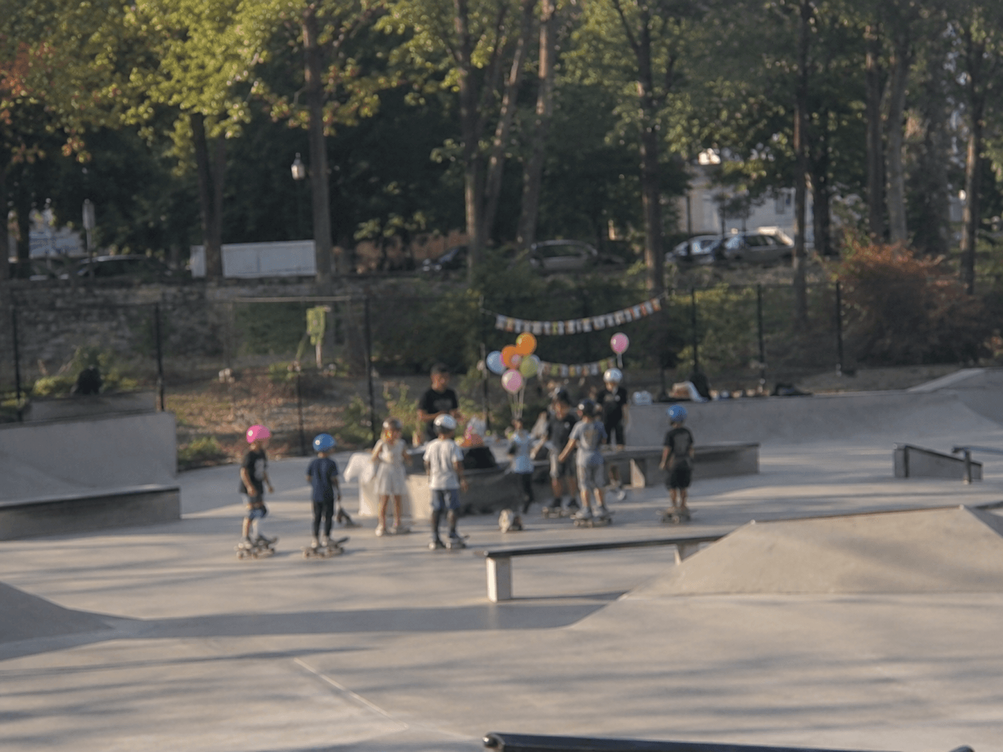 Kids at a birthday party learning to skateboard at a Westchester park